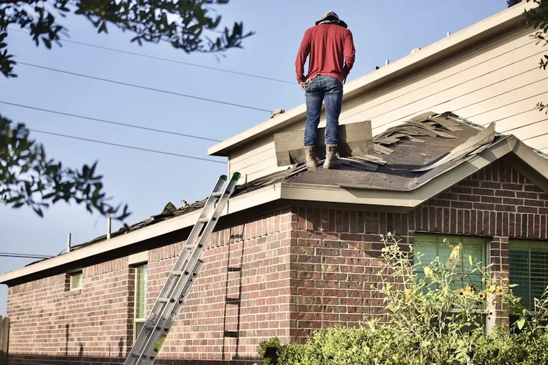 Professional roofer working on a residential roof in Ranchettes